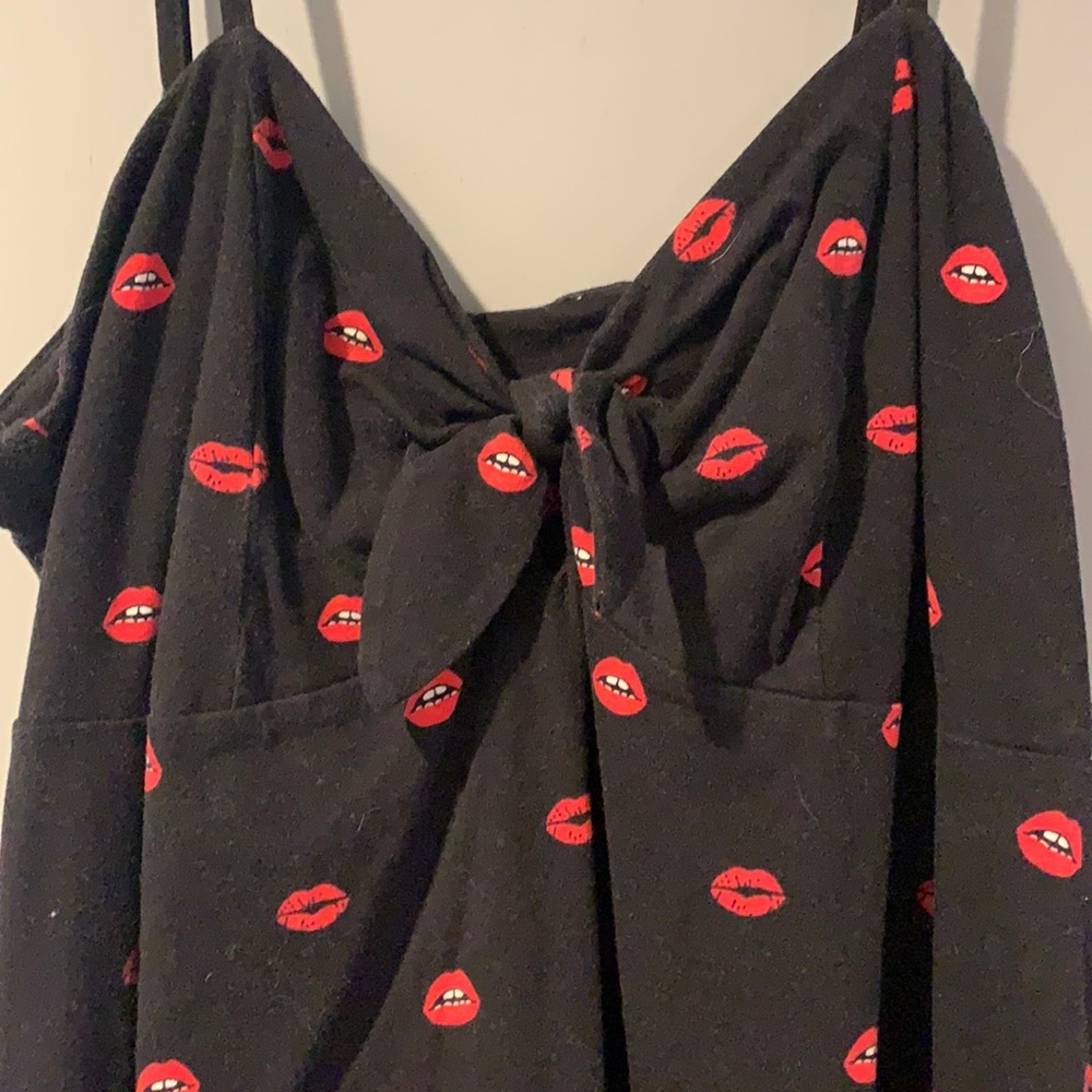 Black mini dress with red lips detail.